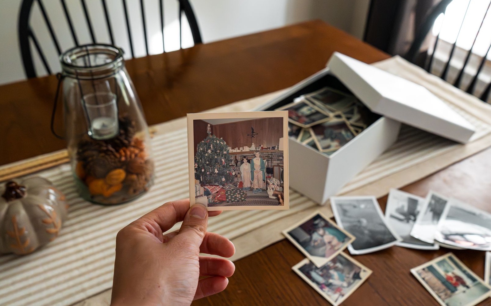 A collection of vintage family photographs on a wooden table